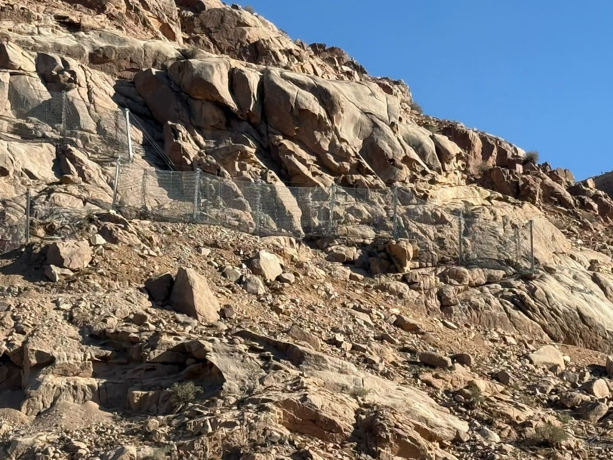 Rockfall barrier protecting a road below a slope